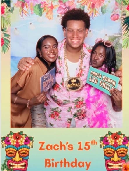 Three guests posing with birthday props